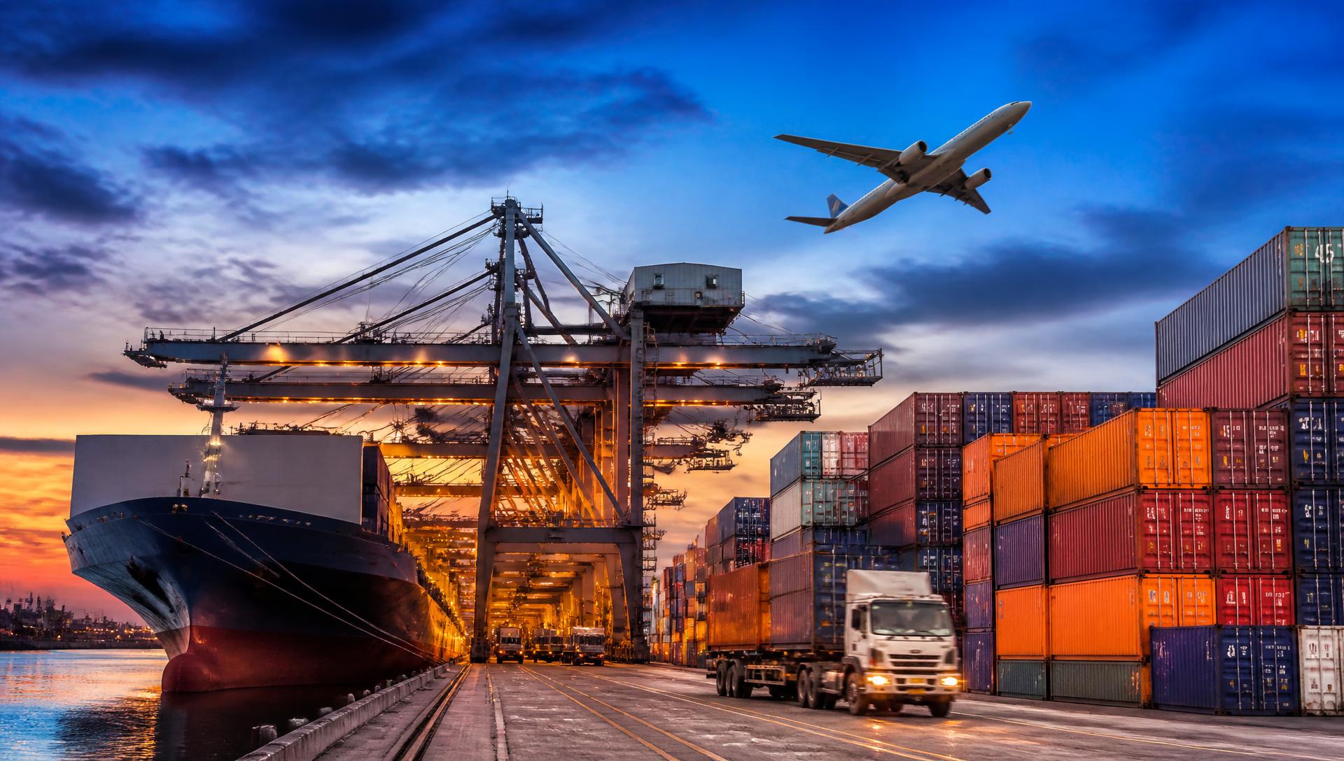 Container port at dusk with cranes, a cargo ship and a freight aircraft